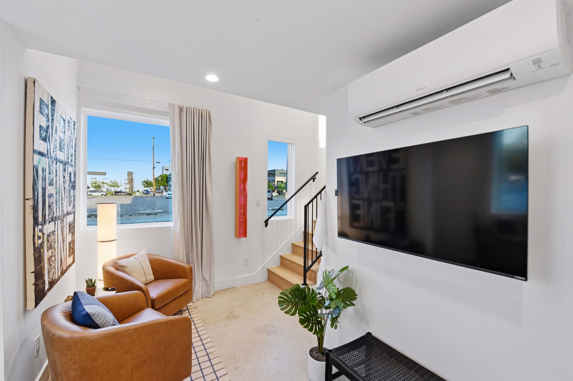 A casita living room with a large photo-collage artwork and a red sculptural piece