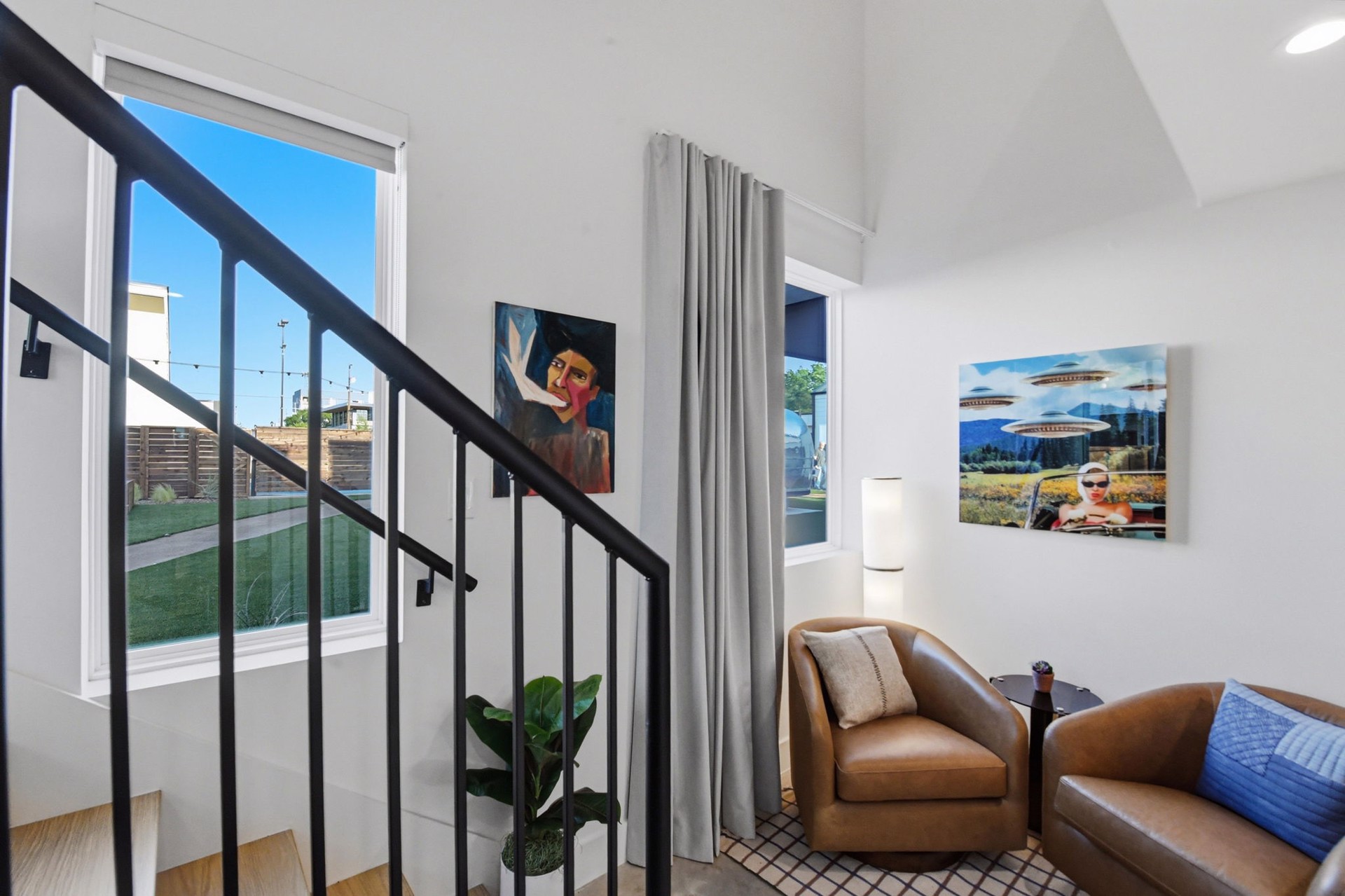 A SOMA casita living area with a portrait painting and a pop-art piece from the William Campbell Gallery collection