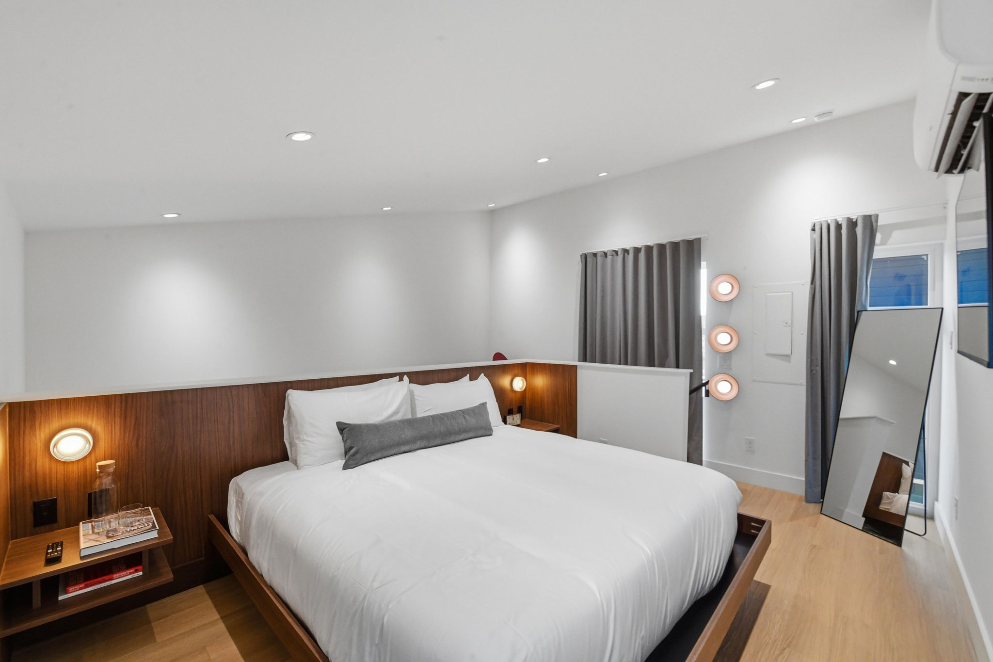 King bed and walnut-paneled interior of a SOMA casita