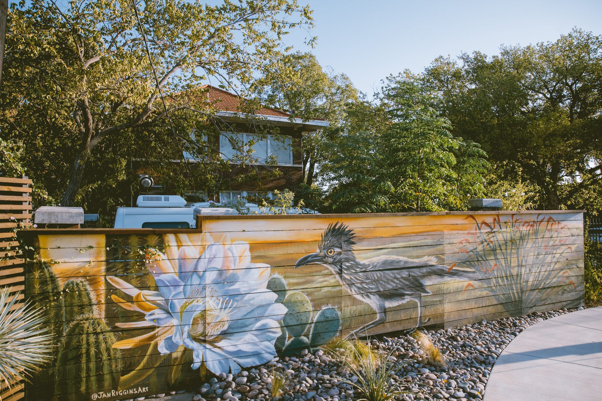 Roadrunner and cactus-bloom mural along the Hotel SOMA courtyard fence