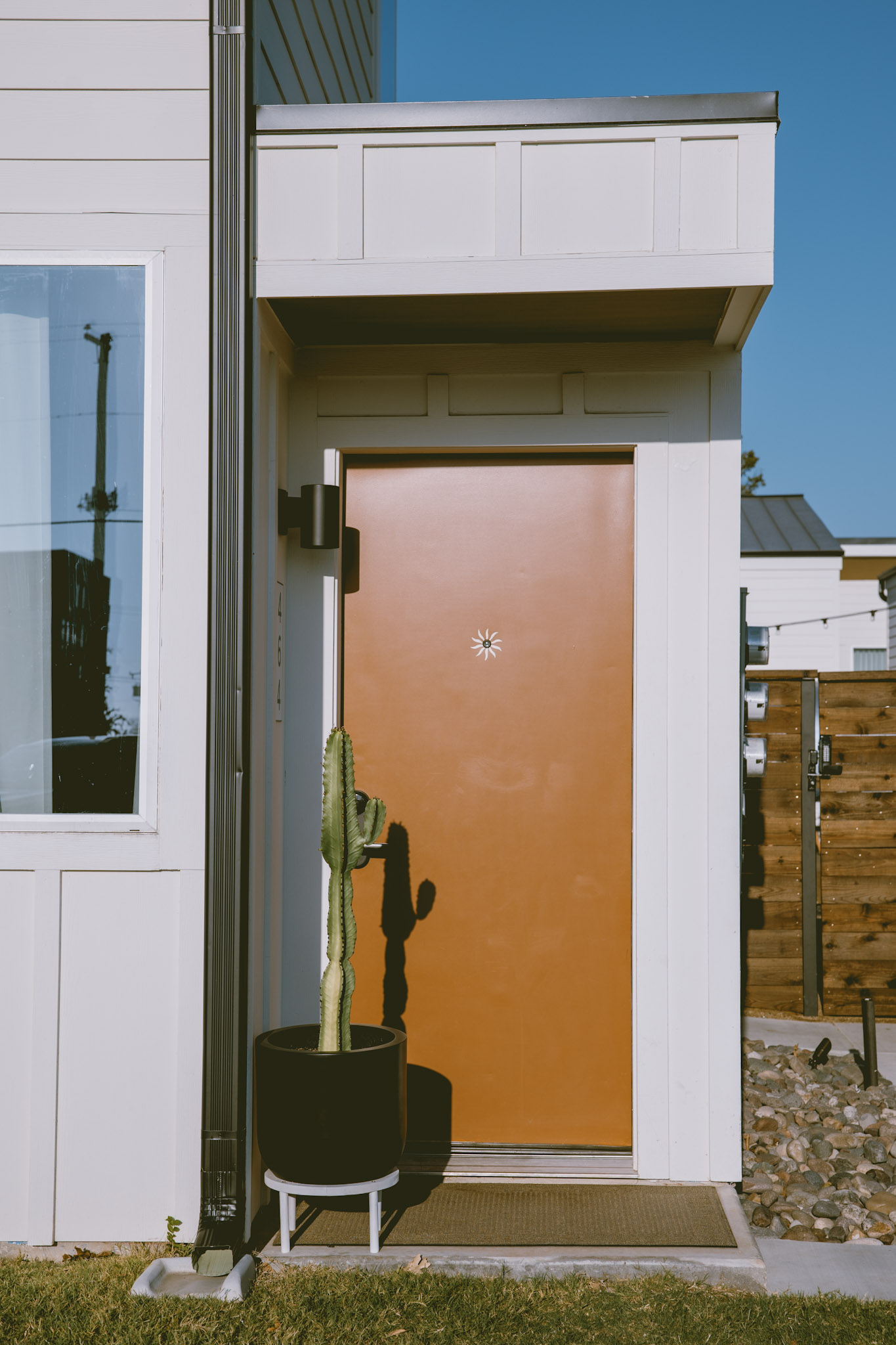 A casita's private orange front door at Hotel SOMA in South Main Village, Fort Worth